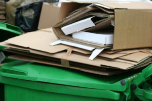Proper business recycling is about protecting your confidential materials. Recycling on top of a business recycling bin.