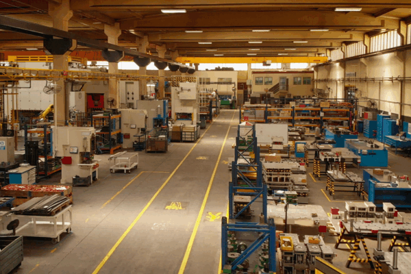 Wide view of a manufacturing plant floor, showing equipment, storage racks, and production zones relevant to manufacturing plant recycling workflows.