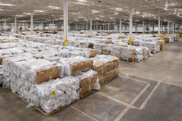 LDPE plastic film recycling guide showing large-scale warehouse storage of baled LDPE plastic film ready for commercial recycling.
